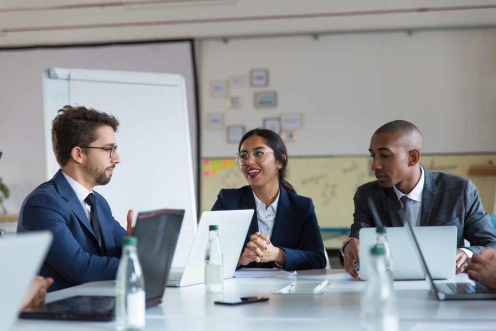 Group of cheerful managers communicating in a meeting